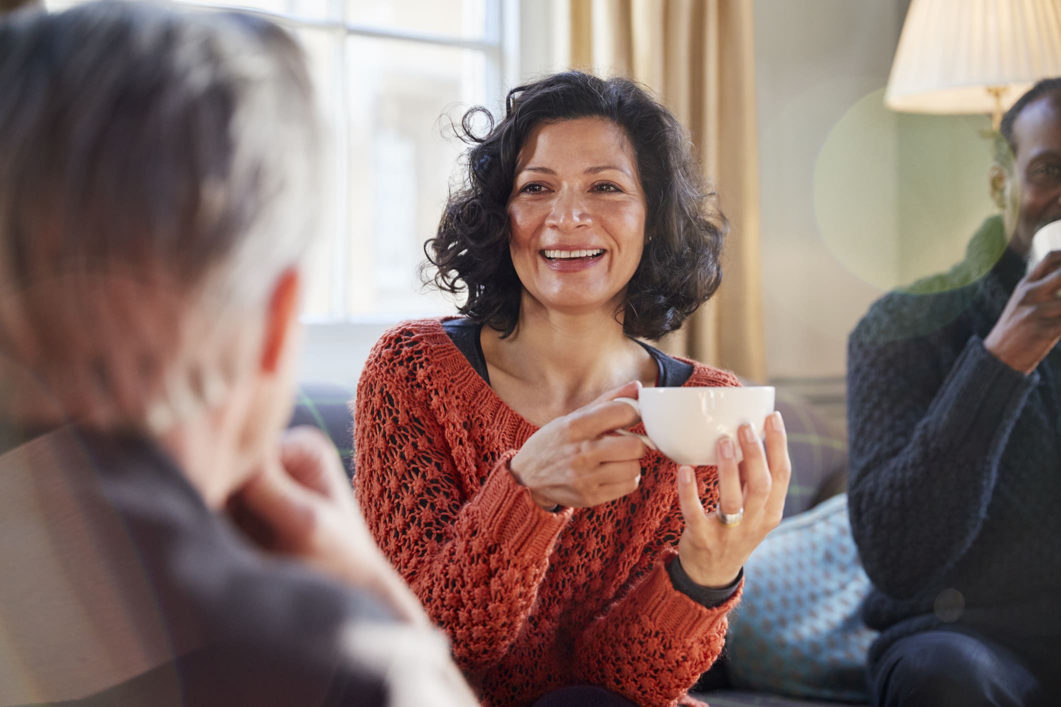 Middle Aged Woman Meeting Friends Around Table In Coffee Shop Anti Aging Treatments (Skin Treatments) in Jacksonville, FL