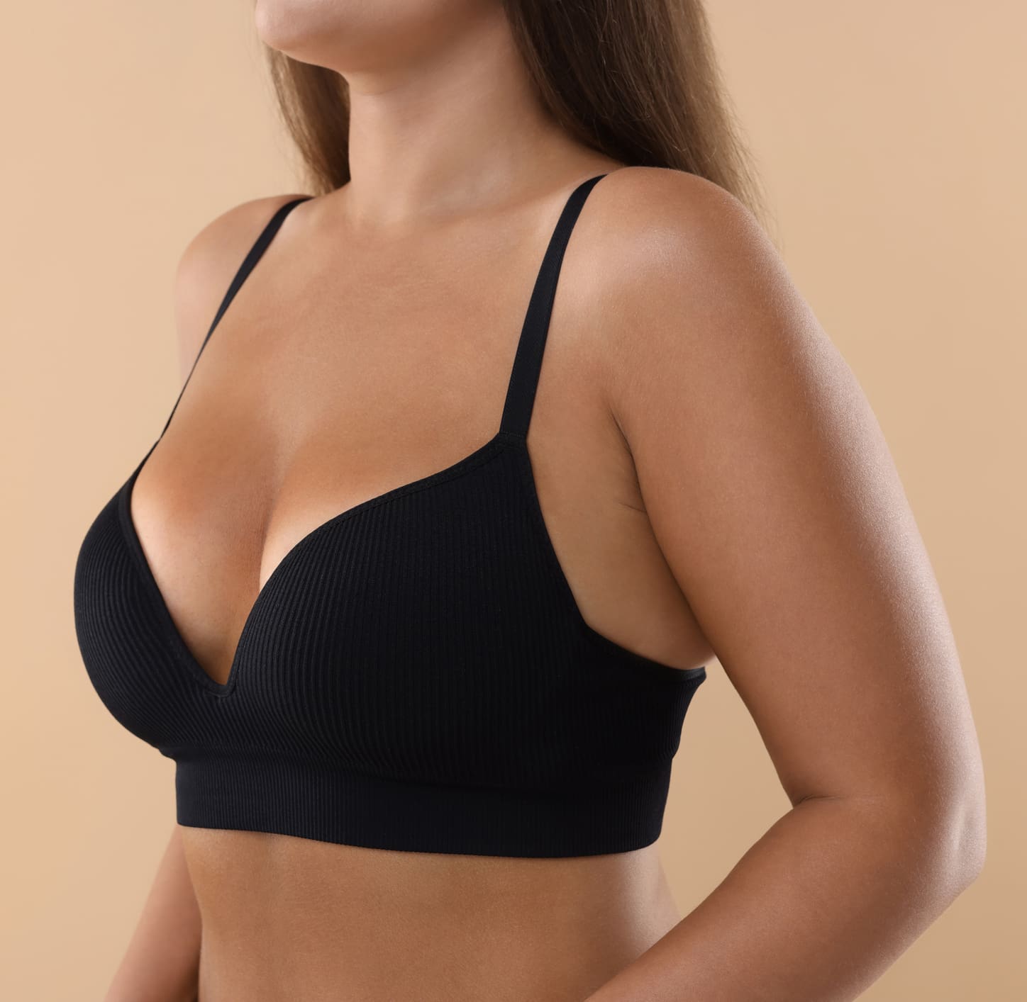 Woman with beautiful breast on beige background, closeup. Space for text Anti Aging Treatments (Skin Treatments) in Jacksonville, FL